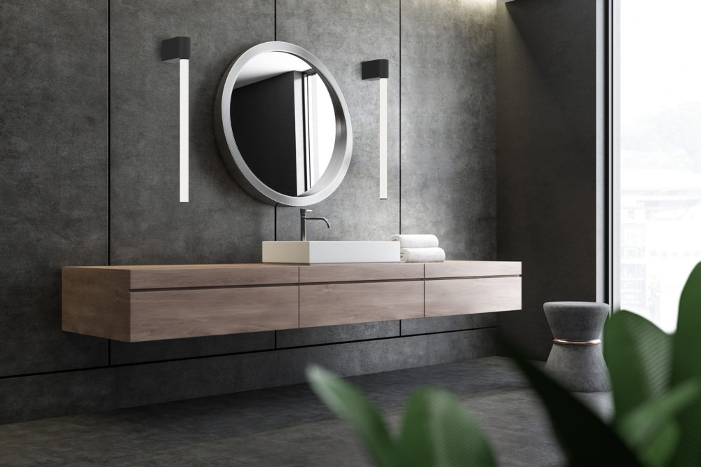 Sink and mirror in concrete bathroom corner